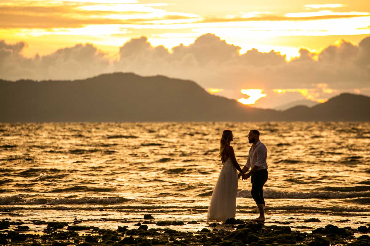 Honeymoon photography for Mike with Justine on beauiful beach during sunset Krabi Thailand.